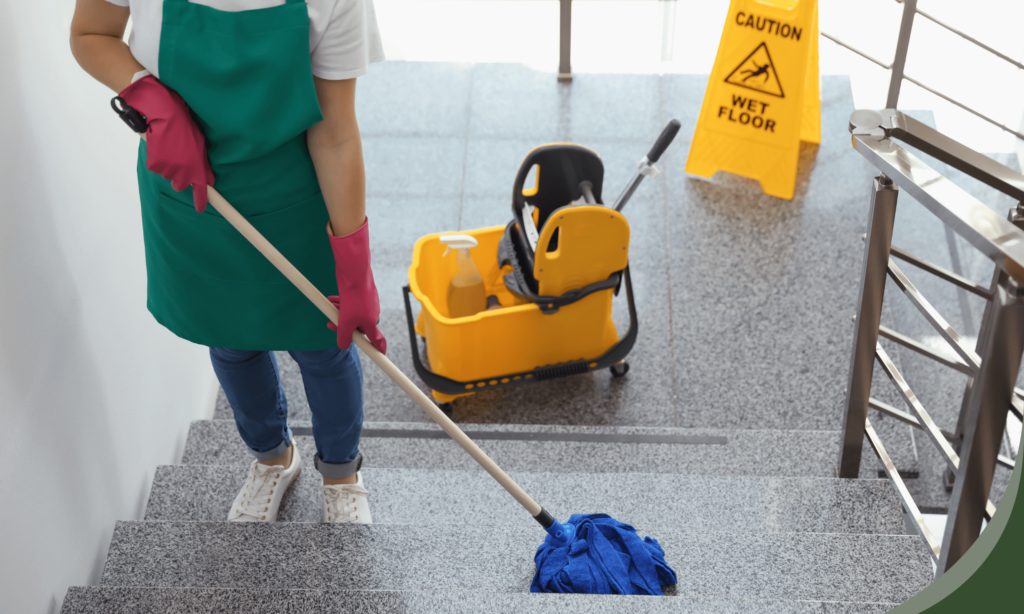 Person cleaning a commercial building staircase